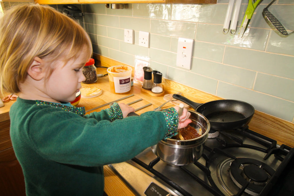 Daughter mixing ingredients for nut butter cups